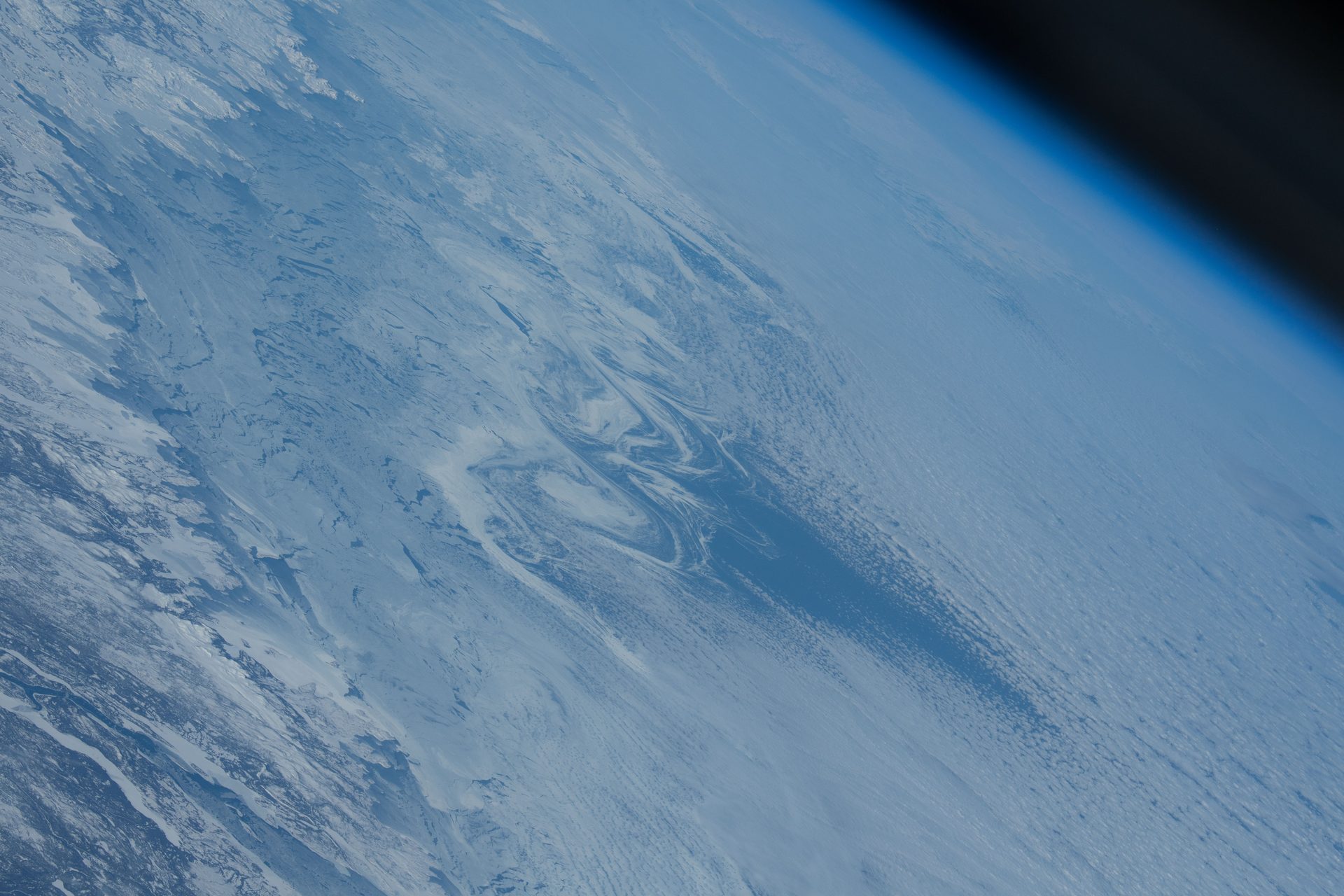 Swirls of sea ice tracing ocean currents along the coast of Labrador in eastern Canada, photographed from the International Space Station