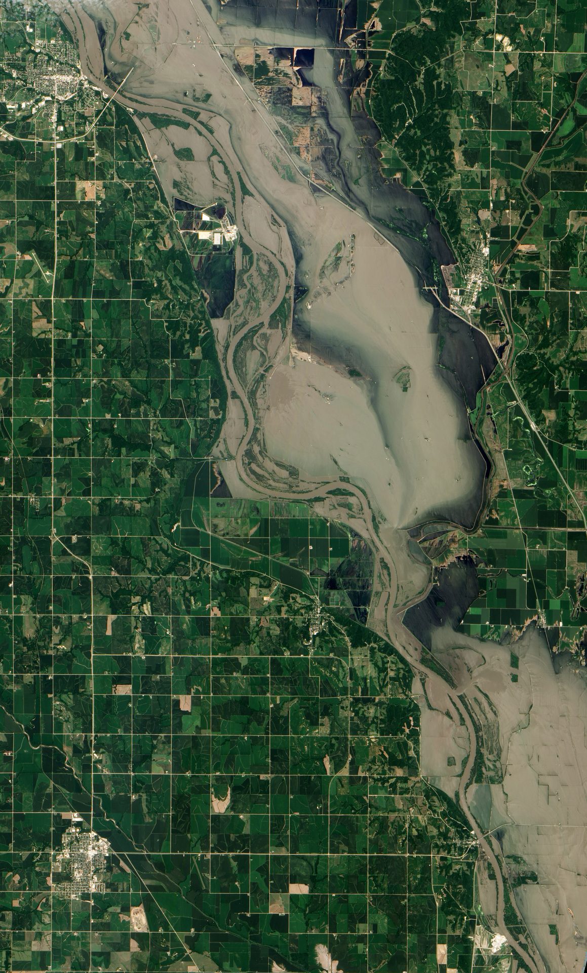 Muddy floodwater from the Missouri River covering fields near Hamburg, Iowa, seen from orbit